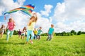 Cute group of kids run with kite Royalty Free Stock Photo