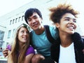 Cute group of teenages at the building of university with books huggings, back to school Royalty Free Stock Photo