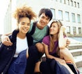 Cute group of teenages at the building of university with books huggings, back to school Royalty Free Stock Photo