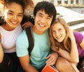 Cute group of teenages at the building of university with books huggings, back to school Royalty Free Stock Photo