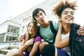 Cute group of teenages at the building of university with books huggings, diversity nations students lifestyle Royalty Free Stock Photo