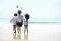 Cute groups of kids have fun together on sandy summer beach with blue sea, happy childhood friends play on tropical beach, Royalty Free Stock Photo