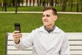 Cute guy doing selfie on phone, picture of himself Royalty Free Stock Photo