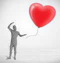 Cute guy in morpsuit body suit looking at a balloon shaped heart