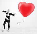 Cute guy in morpsuit body suit looking at a balloon shaped heart