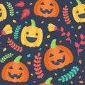 Cute Halloween seamless pattern. Pumpkins, leaves and flowers floating on a dark background. Royalty Free Stock Photo