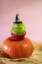Cute Halloween witch cupcake on pumpkin