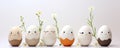 Cute handmade eggs with funny faces and spring flowers on light background. Happy Easter Royalty Free Stock Photo