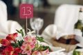 Cute handmade table number close-up at wedding reception in luxury restaurant, table number sign on flowers bouquet at restaurant Royalty Free Stock Photo