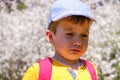 Cute handsome caucasian child is crying outdoor. Sorrowful