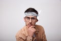 Funny young man with glasses looks into the camera Royalty Free Stock Photo