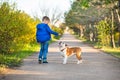 Cute handsome stylish boy enjoying colourful autumn park with his best friend red and white english bull dog.Delightfull