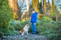 Cute handsome stylish boy enjoying colourful autumn park with his best friend red and white english bull dog.Delightfull