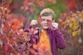 Cute handsome stylish boy enjoying colourful autumn park with his best friend red and white english bull dog.Delightfull Royalty Free Stock Photo