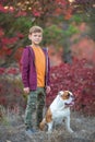 Cute handsome stylish boy enjoying colourful autumn park with his best friend red and white english bull dog.Delightfull