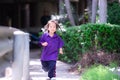 Cute happy Asian child girl is running to his father or mother and smiling sweetly. Royalty Free Stock Photo