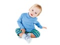 Cute happy baby blonde in a blue sweater playing and smiling on white Royalty Free Stock Photo