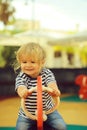 Cute happy baby boy ride seesaw