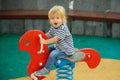 Cute happy baby boy riding red spring rider Royalty Free Stock Photo