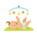 Cute happy baby in a diaper lying in bed and having fun with toy carousel, colorful cartoon character vector Royalty Free Stock Photo