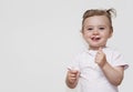 Cute happy baby girl is laughing fearless. looking in to camera. Royalty Free Stock Photo