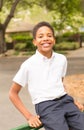 Cute Happy Black Boy Sitting on Gate Royalty Free Stock Photo