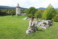 Cute happy boy climbing on rock in front of old town Dreznik Royalty Free Stock Photo