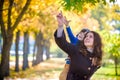 Cute, happy, boy smiling and hugging with his mom among yellow l Royalty Free Stock Photo