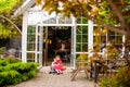 Cute and happy brother and sister sitting on the porch of a country house. Royalty Free Stock Photo