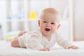 Cute happy caucasian baby boy in white shirt lies smiling on bed Royalty Free Stock Photo