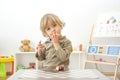 Cute happy child boy having fun eating chocolate cake at home. Chocolate, sweets and sugar, unhealthy food for children conceptual Royalty Free Stock Photo