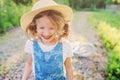 Cute happy child girl with bicycle on summer sunny road Royalty Free Stock Photo