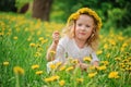 Cute happy child girl on dandelion flower field Royalty Free Stock Photo