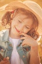 Cute happy child girl in hat portrait in summer