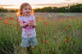 Cute happy child girl in poppy field. Happy childhood concept Royalty Free Stock Photo