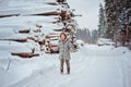 Cute happy child girl portrait on the walk in winter forest with tree felling on background Royalty Free Stock Photo