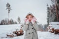 Cute happy child girl portrait on the walk in winter snowy forest Royalty Free Stock Photo