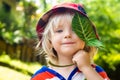 Cute happy child holding a leaf