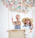 Happy children in a fairy magic hot air balloon Royalty Free Stock Photo