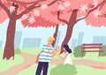 Cute happy couple viewing cherry tree blossom in spring. Young man and woman walking at city park with blooming Japanese