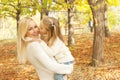 Cute happy daughter kissing her mother in cheek Royalty Free Stock Photo