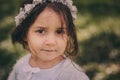 Cute happy dreamy toddler child girl walking in blooming spring garden, celebrating easter outdoor