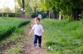 Cute happy funny little baby boy running on dirt road