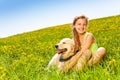 Cute happy girl cuddling dog in summer