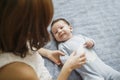 Cute happy girl holding her newborn baby brother. Gray background. Pretty baby boy in blue clothes Royalty Free Stock Photo