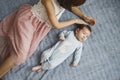 Cute happy girl holding her newborn baby brother. Gray background. Pretty baby boy in blue clothes Royalty Free Stock Photo