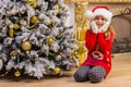 Cute happy girl in red hat sitting and smiling Royalty Free Stock Photo