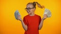 Cute happy girl showing bunches of dollar cash, wunderkind winning grant, income