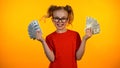 Cute happy girl showing bunches of dollar cash, wunderkind winning grant, income