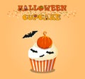 Cute happy halloween cupcake with pumpkin and bats on orange